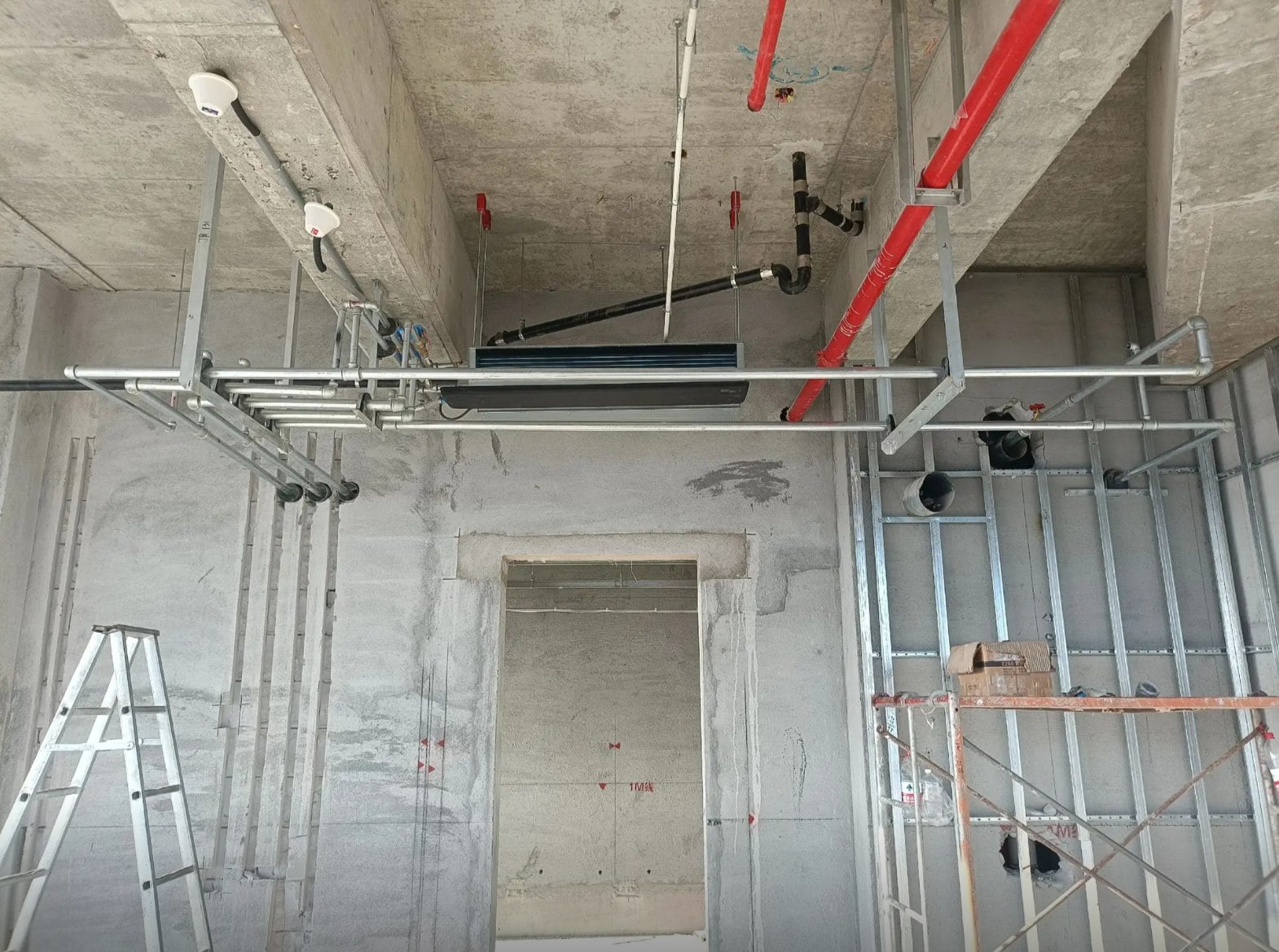 Ceiling fan coil unit installed with pipework before ceiling closure