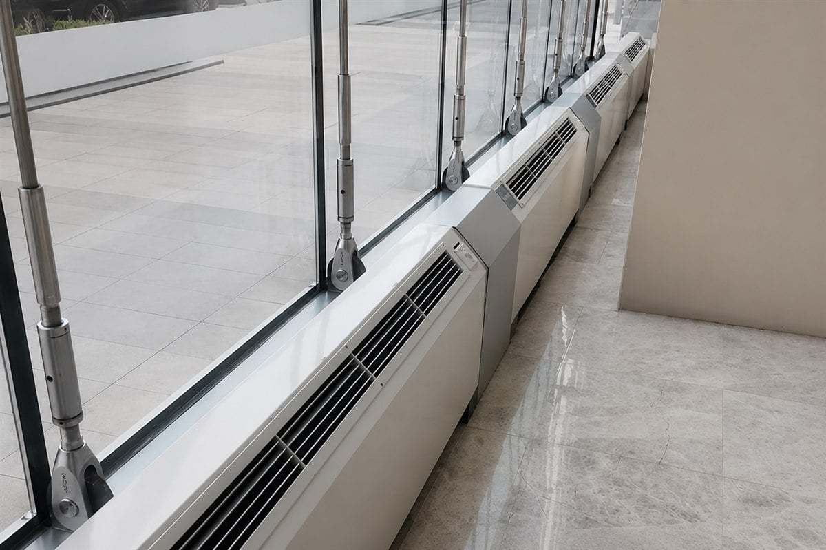 Vertical fan coil units installed along a window wall