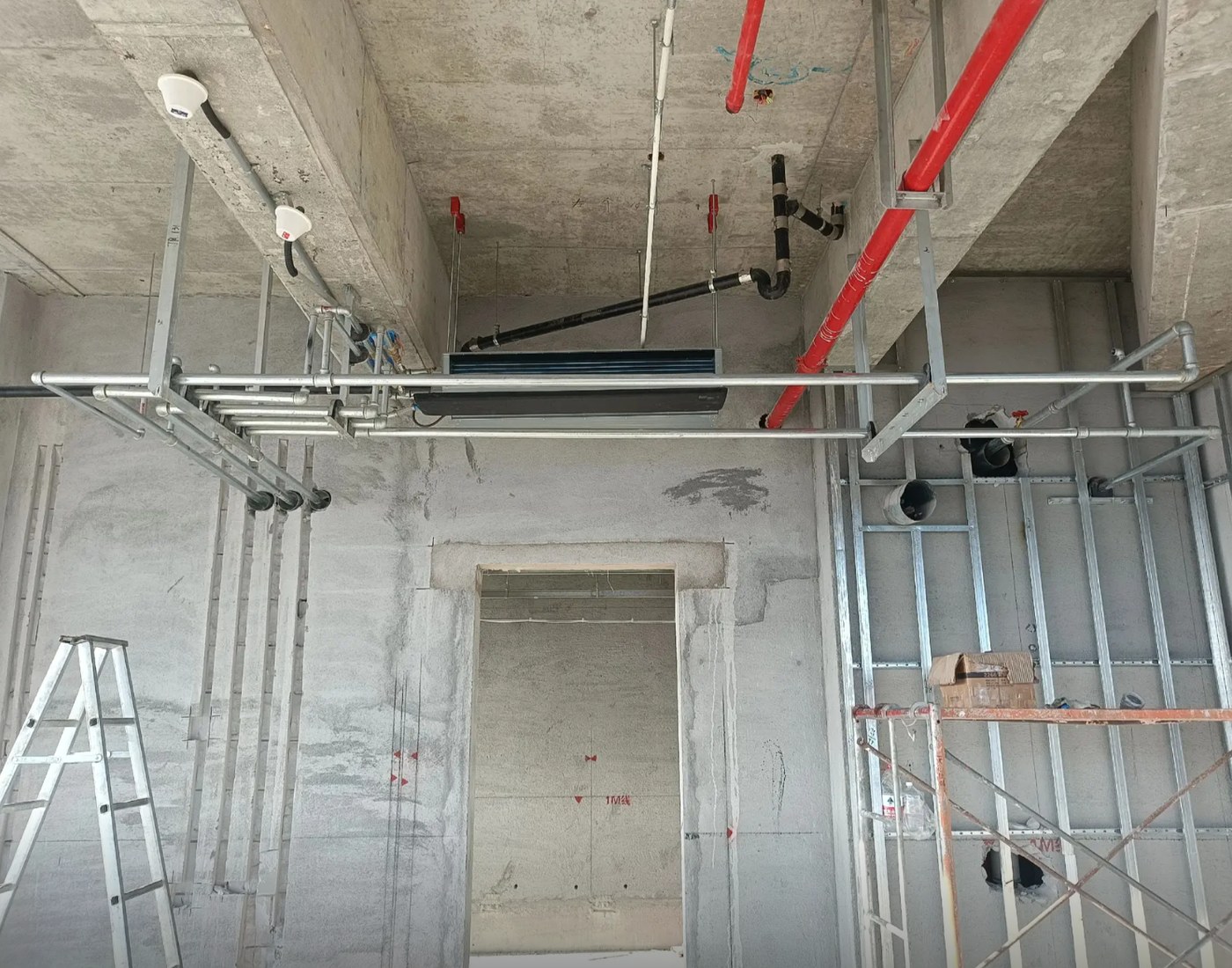 Horizontal concealed fan coil installed in a tight ceiling plenum with hangers, piping and condensate drain coordination