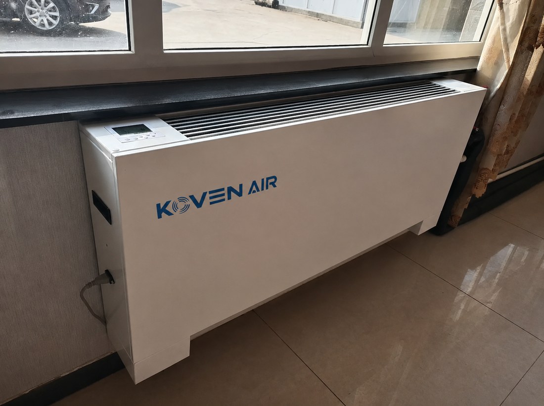 KOVEN AIR floor-standing vertical fan coil unit installed under a window